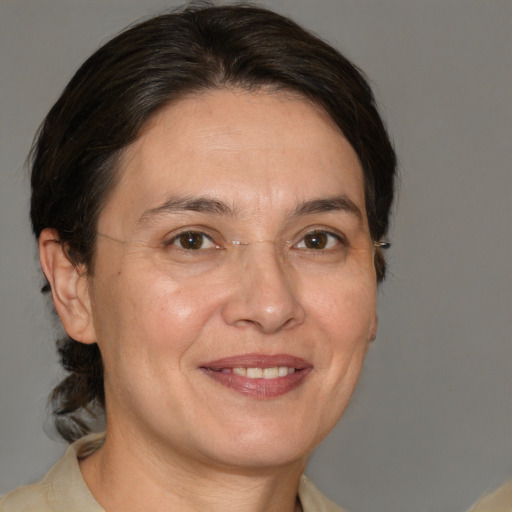 Joyful white adult female with medium  brown hair and brown eyes