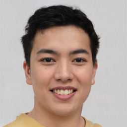 Joyful asian young-adult male with short  brown hair and brown eyes