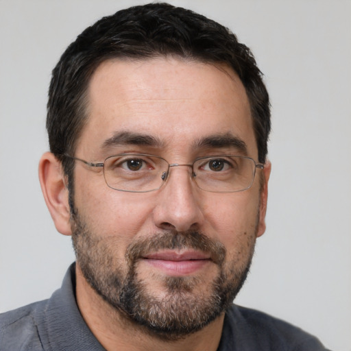 Joyful white adult male with short  brown hair and brown eyes