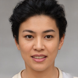 Joyful asian young-adult female with short  brown hair and brown eyes