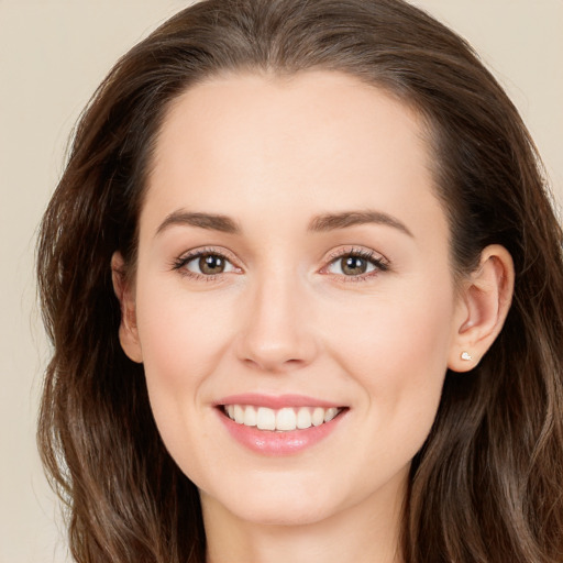 Joyful white young-adult female with long  brown hair and brown eyes