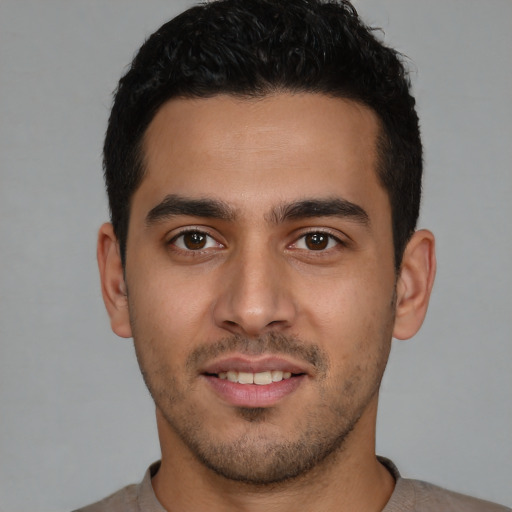 Joyful white young-adult male with short  black hair and brown eyes