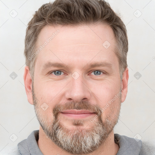 Joyful white adult male with short  brown hair and grey eyes