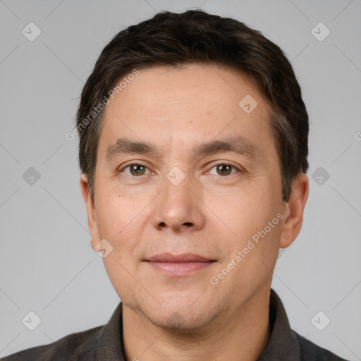 Joyful white adult male with short  brown hair and brown eyes