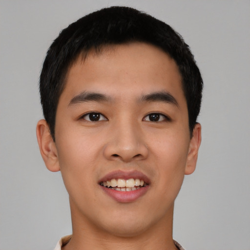 Joyful asian young-adult male with short  black hair and brown eyes