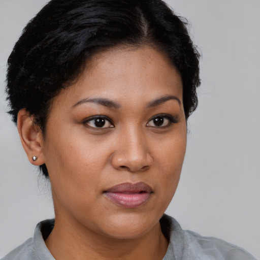 Joyful latino young-adult female with short  brown hair and brown eyes