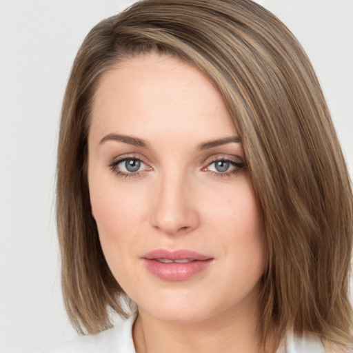 Joyful white young-adult female with medium  brown hair and green eyes