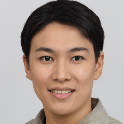 Joyful asian young-adult male with short  brown hair and brown eyes