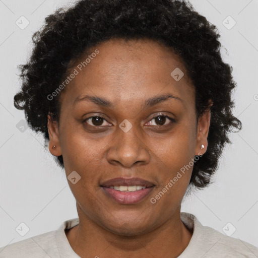 Joyful black adult female with short  brown hair and brown eyes