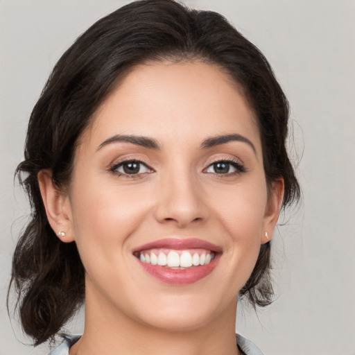 Joyful white young-adult female with medium  brown hair and brown eyes