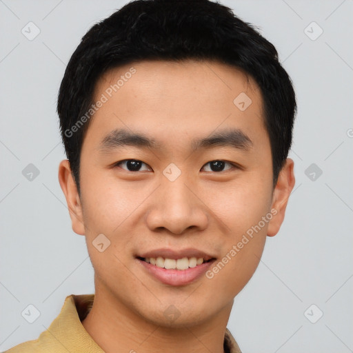 Joyful asian young-adult male with short  black hair and brown eyes