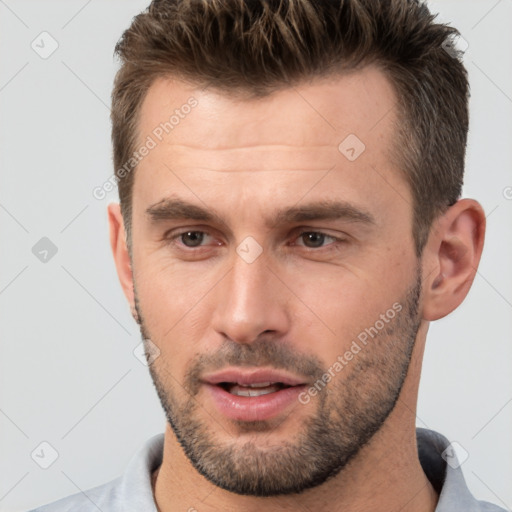 Joyful white young-adult male with short  brown hair and brown eyes