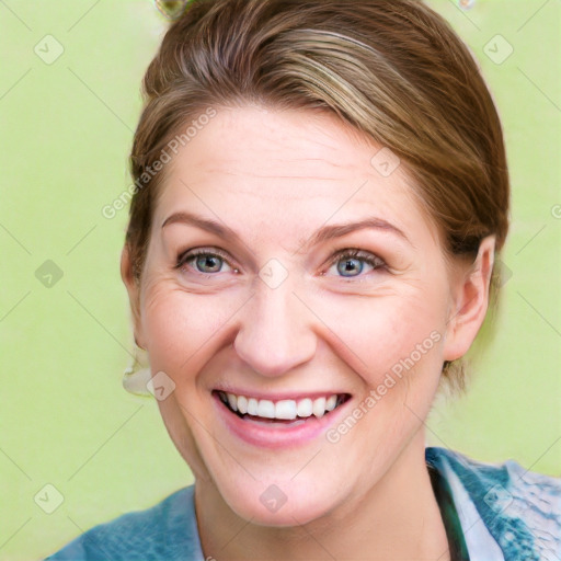 Joyful white adult female with medium  brown hair and blue eyes