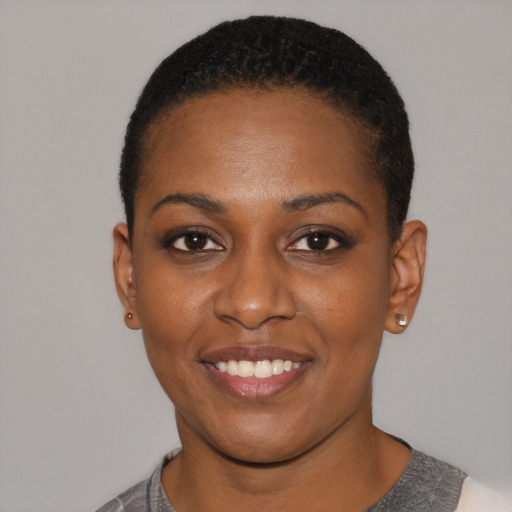 Joyful black young-adult female with short  black hair and brown eyes
