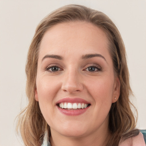 Joyful white young-adult female with long  brown hair and grey eyes