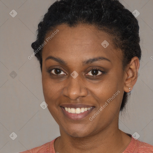 Joyful black young-adult female with short  black hair and brown eyes