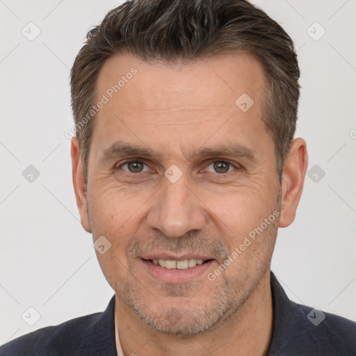 Joyful white adult male with short  brown hair and brown eyes