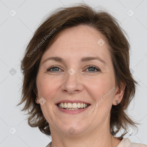 Joyful white adult female with medium  brown hair and grey eyes