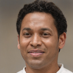 Joyful latino adult male with short  brown hair and brown eyes