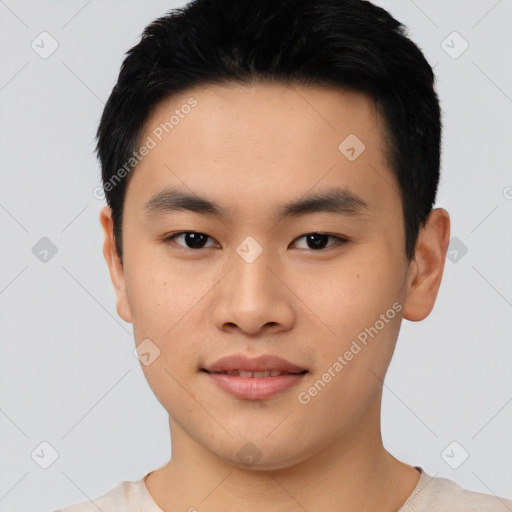 Joyful asian young-adult male with short  black hair and brown eyes