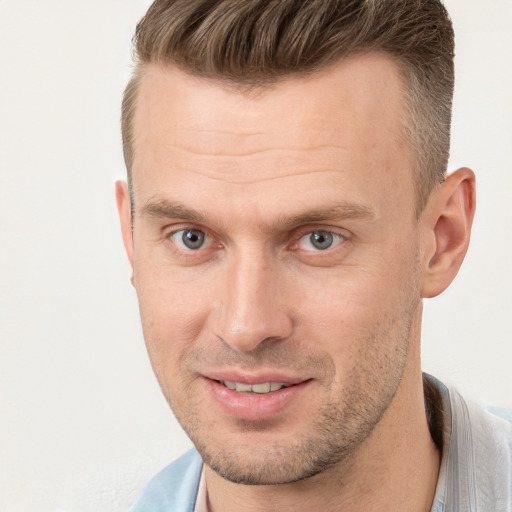 Joyful white young-adult male with short  brown hair and brown eyes