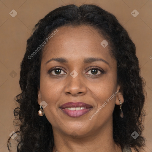 Joyful black young-adult female with long  brown hair and brown eyes