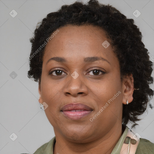 Joyful black adult female with short  brown hair and brown eyes