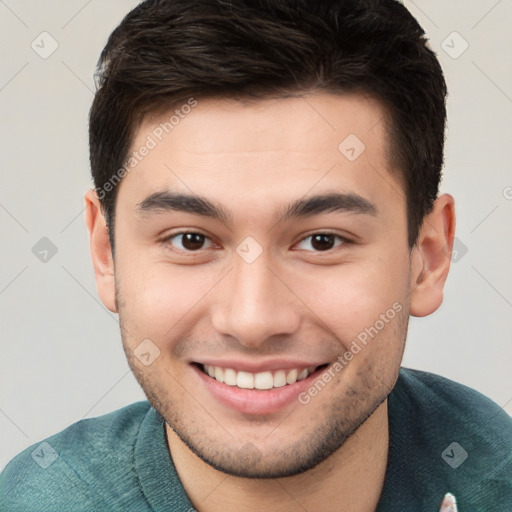 Joyful white young-adult male with short  brown hair and brown eyes