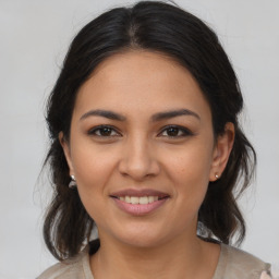 Joyful latino young-adult female with medium  brown hair and brown eyes