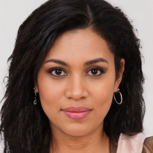 Joyful latino young-adult female with long  brown hair and brown eyes