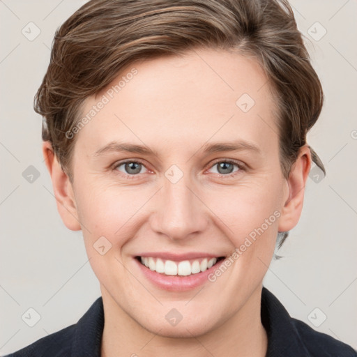 Joyful white young-adult female with short  brown hair and grey eyes