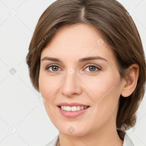 Joyful white young-adult female with medium  brown hair and grey eyes