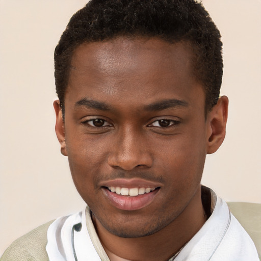 Joyful black young-adult male with short  brown hair and brown eyes