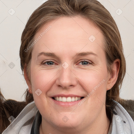 Joyful white adult female with medium  brown hair and grey eyes