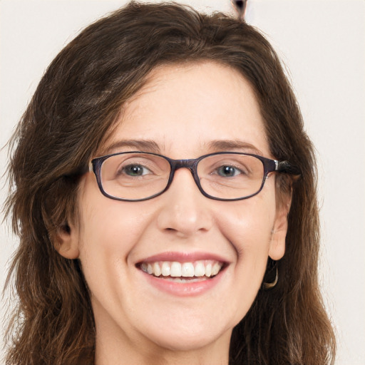 Joyful white adult female with long  brown hair and brown eyes