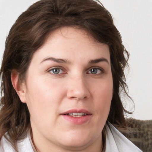 Joyful white young-adult female with medium  brown hair and blue eyes