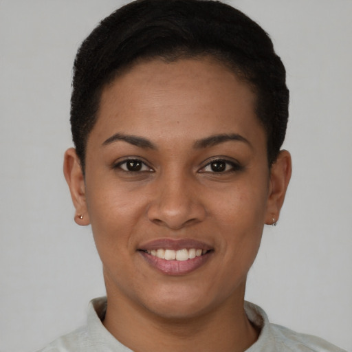 Joyful latino young-adult female with short  black hair and brown eyes