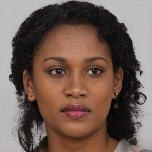 Neutral black young-adult female with long  brown hair and brown eyes