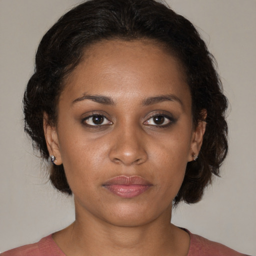 Joyful black young-adult female with medium  brown hair and brown eyes