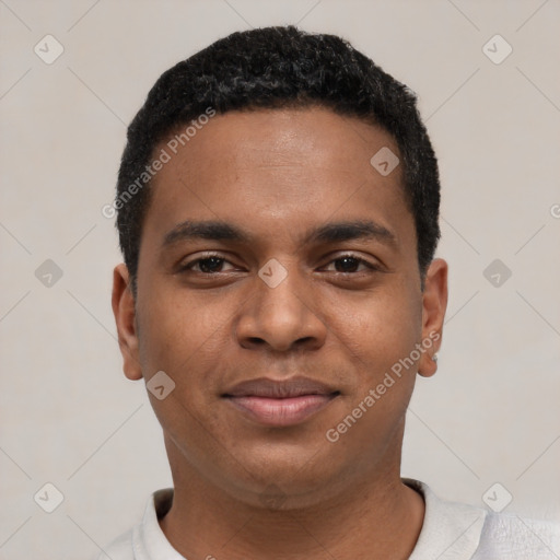 Joyful black young-adult male with short  black hair and brown eyes