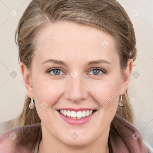 Joyful white young-adult female with medium  brown hair and blue eyes