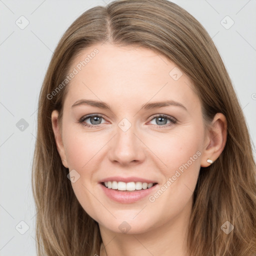 Joyful white young-adult female with long  brown hair and grey eyes