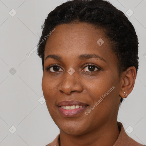 Joyful black young-adult female with short  brown hair and brown eyes