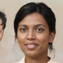 Joyful latino young-adult female with medium  brown hair and brown eyes