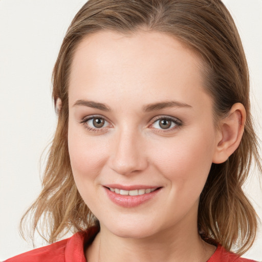 Joyful white young-adult female with medium  brown hair and blue eyes