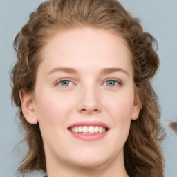 Joyful white young-adult female with long  brown hair and blue eyes