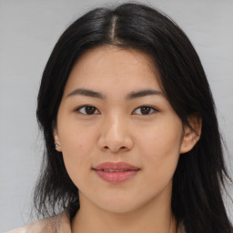 Joyful asian young-adult female with long  black hair and brown eyes