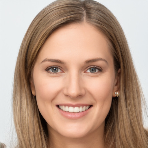 Joyful white young-adult female with long  brown hair and brown eyes