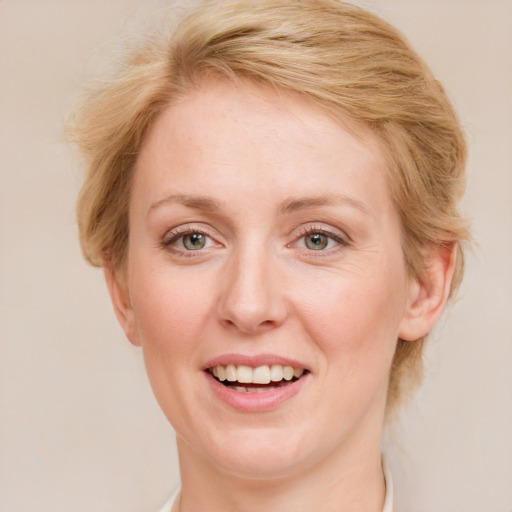 Joyful white adult female with medium  brown hair and blue eyes