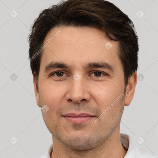 Joyful white adult male with short  brown hair and brown eyes